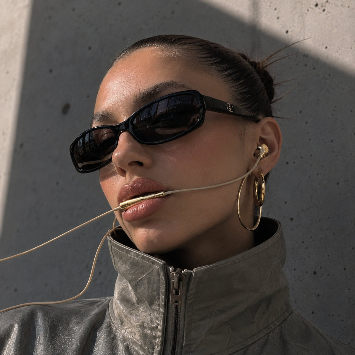 Gold chrome earbuds worn outdoors